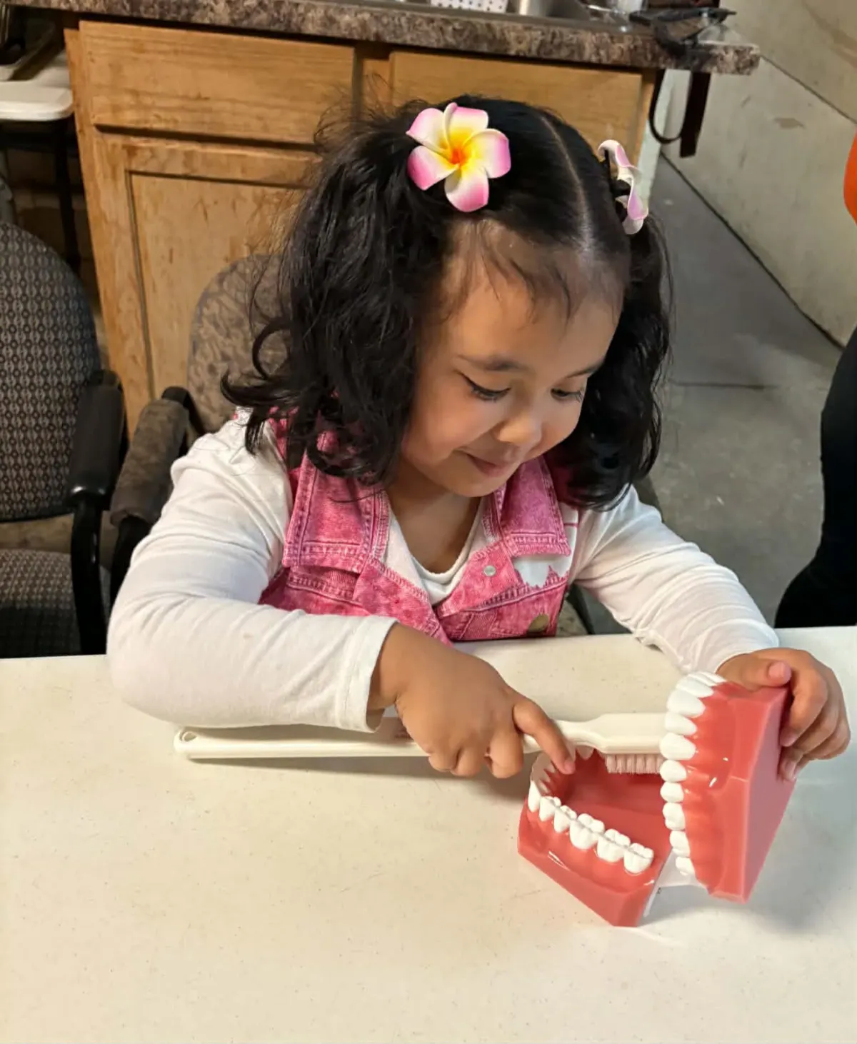 Young participant practicing brushing technique